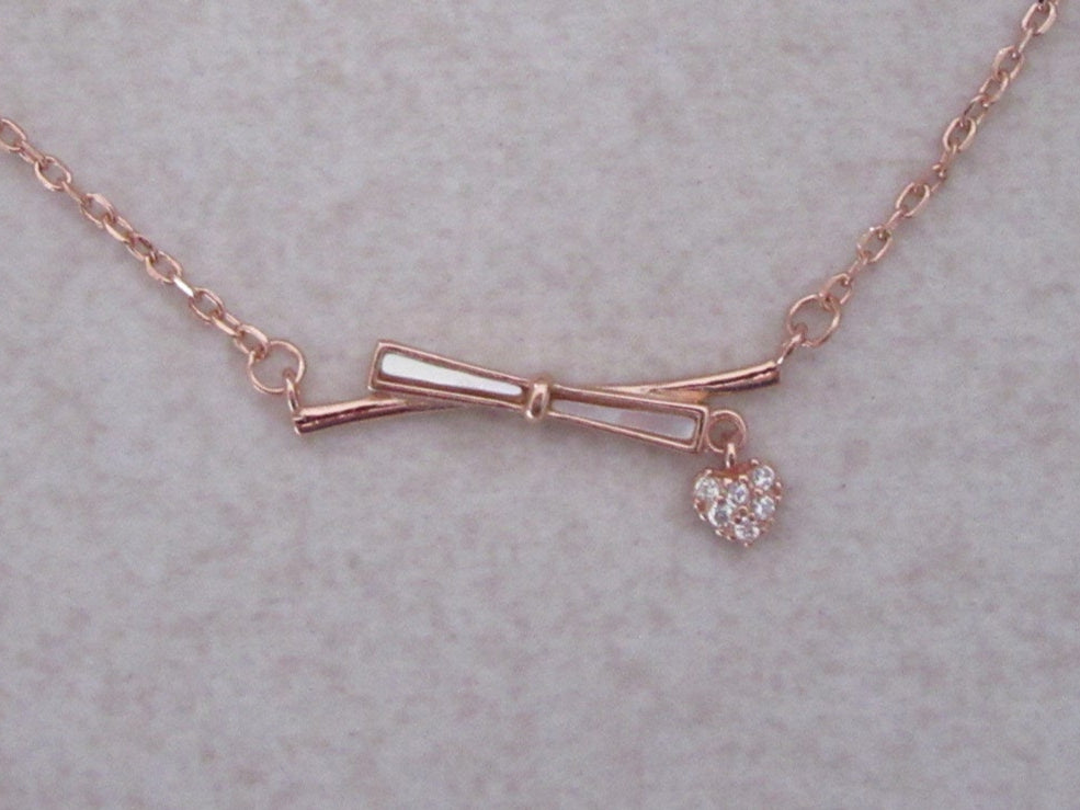 Bow with charm chain and pendant