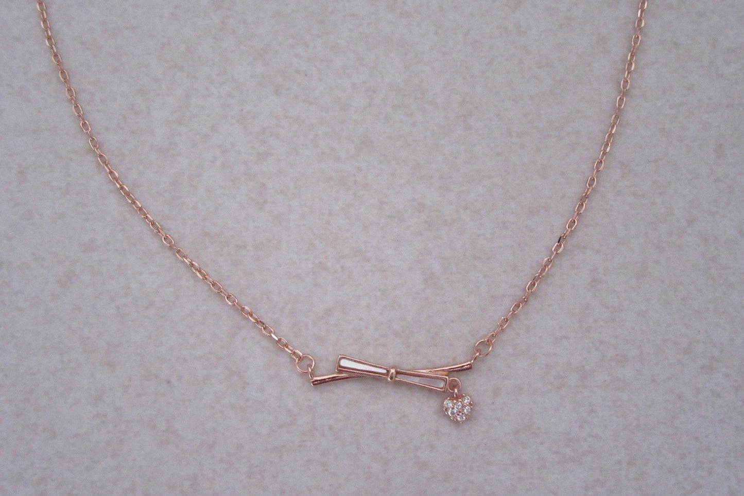 Bow with charm chain and pendant