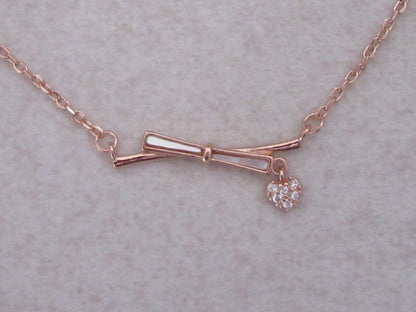 Bow with charm chain and pendant