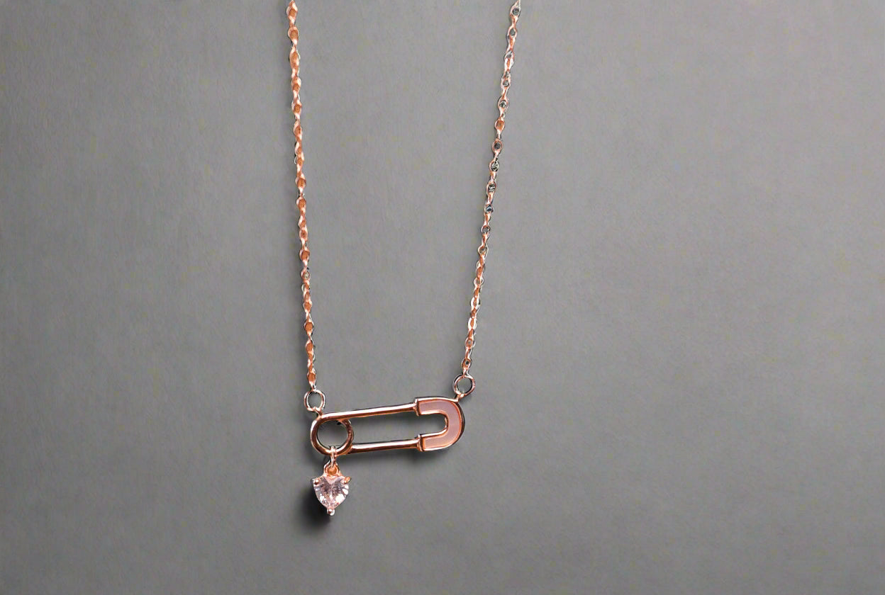 Safety pin with a heart charm pendant and chain