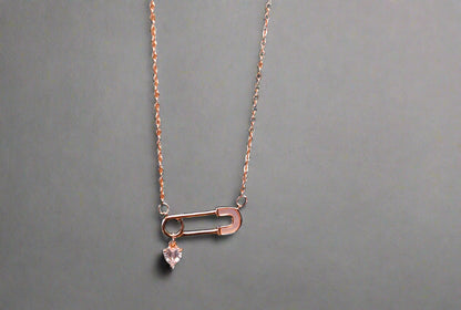 Safety pin with a heart charm pendant and chain