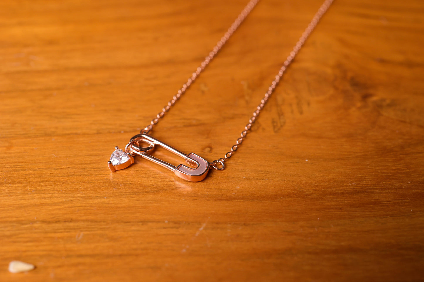 Safety pin with a heart charm pendant and chain